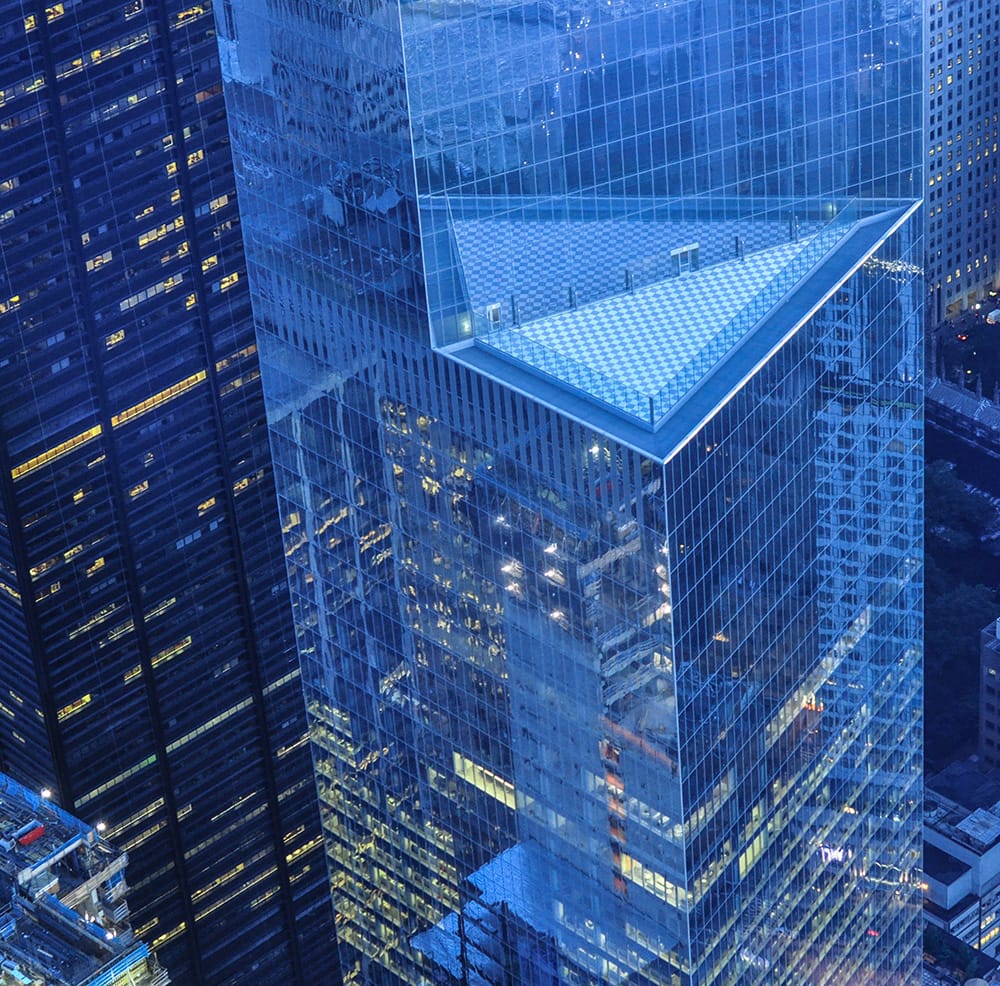 Image of a dusk office building with some windows illuminated